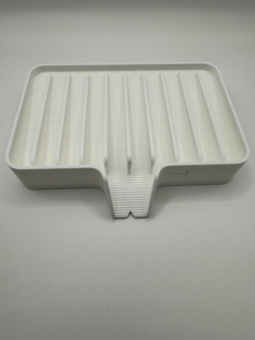 white soap tray with water drain